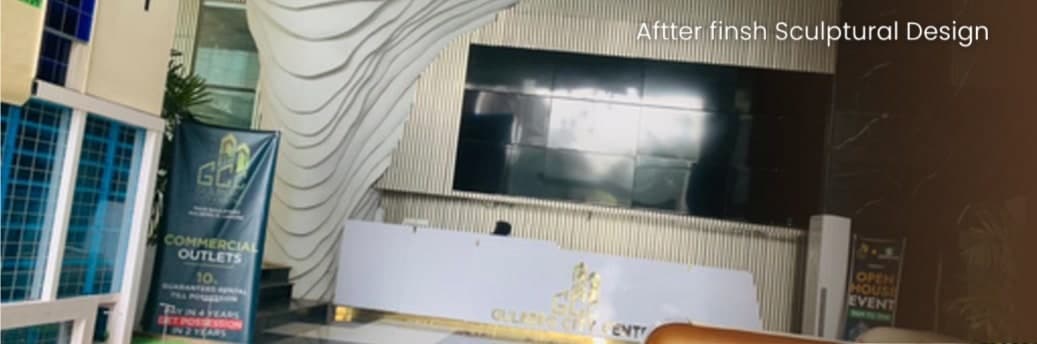 The Gulberg City Center entrance area with a sculptural white parametric wall beside a fluted-panel feature wall and a reception counter.